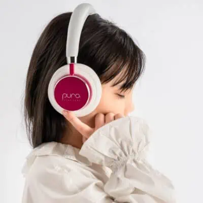 Child listening to Puro Sound Labs Kids Bluetooth Headphones demonstrating a smart gift idea for kids