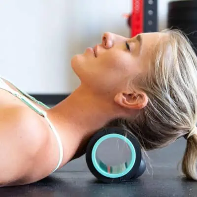 woman demonstrating how to use a 4 inch headache relief chirp wheel as a small gift idea